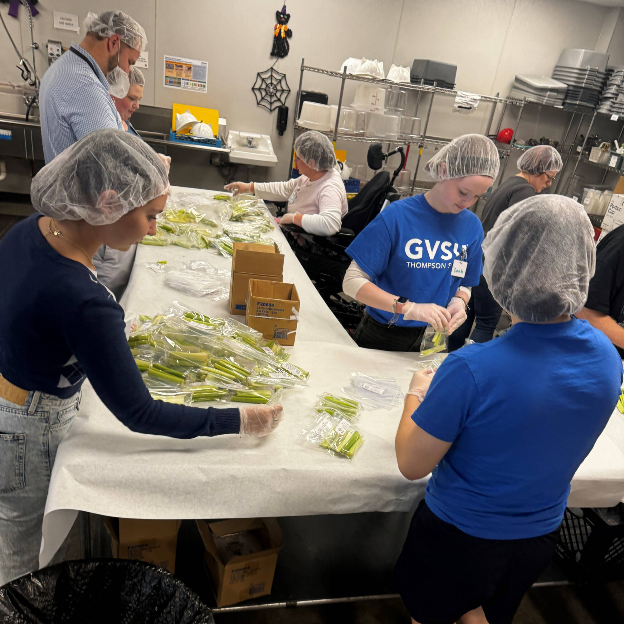 student volunteering at the kids food basket kitchen